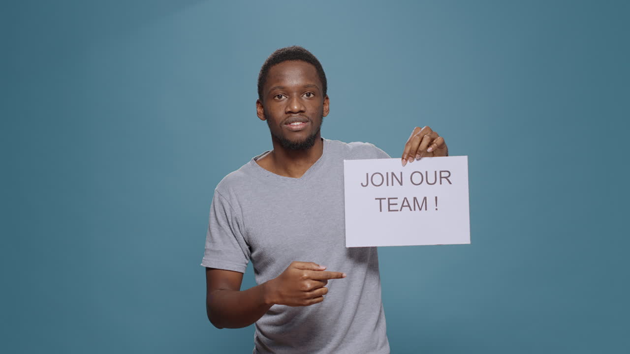 HR recruiter holding job offer and vacancy sign in studio