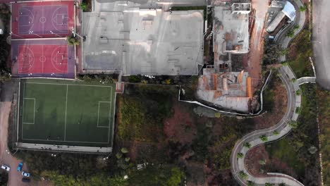 urban park with skate park, sports courts, and construction site