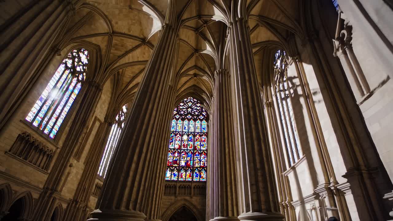 Low-angle video capturing the grandeur of Gothic cathedral interiors, highlighting towering columns