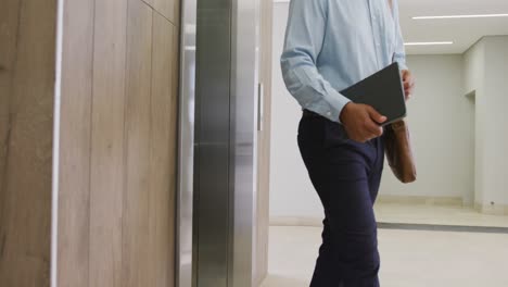 diverse business people taking elevator at office, slow motion