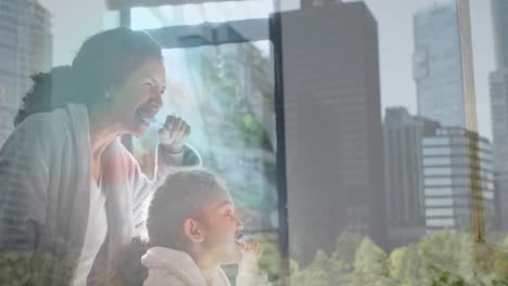 Animation-of-cityscape-over-biracial-mother-and-daughter-brushing-teeth