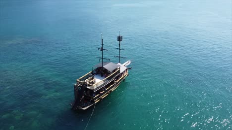 Pirate-ship-set-anchor-off-Coast-of-Island-in-Crystal-Clear-Water-in-Brazilian-Ocean