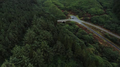 Ancient-bridge-with-a-v-shaped-turn-on-the-road-leading-to-a-gap-in-the-Knockmealdown-mountains-in-Clogheen,-Tipperary,-Ireland