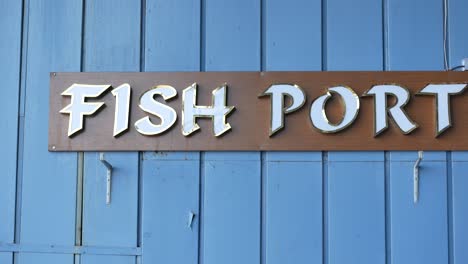 fish port sign on blue wall