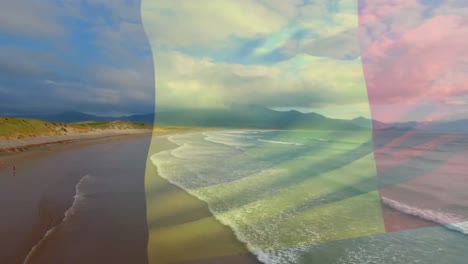 composición digital bandera belga ondeando contra vista aérea de las olas en el mar