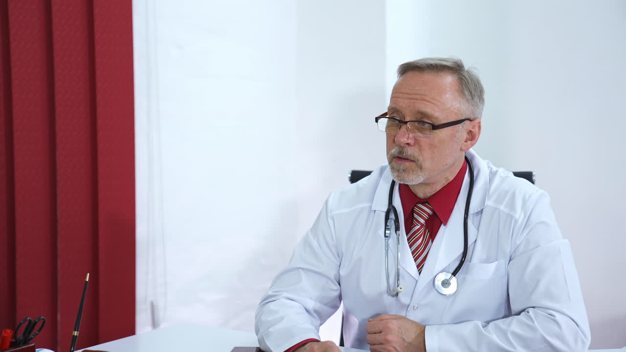 Doctor explaining for patient at hospital. Male doctor discussing with patient in clinic