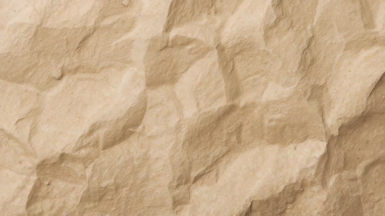 Showing crumpled kraft paper sheet reacting to minor lighting shifts on table, showing texture