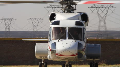 helicopter landing and shutting down on helipad