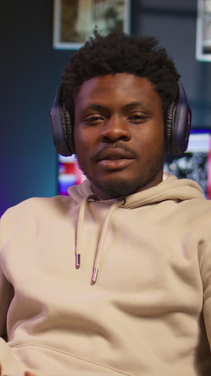 Young Black Man Playing Video Games with Headphones