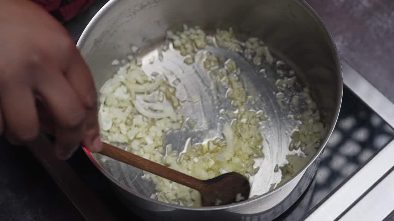 A woman stirring creamy risotto with a ladle in a steaming pot