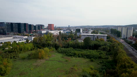 flying over stadion ug with distant view of business buildings in oliwa, gdansk, poland