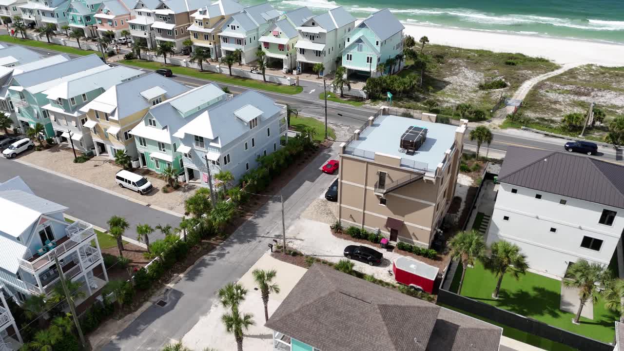 Dynamic drone fly over a red supercar moving on a residential street at luxury area of Panama City Beach, Florida, USA