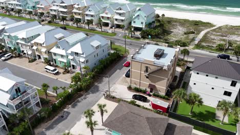 dynamic drone fly over a red supercar moving on a residential street at luxury area of panama city beach, florida, usa