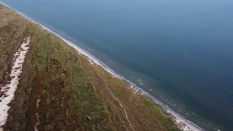 aerial beautiful view of the black sea with waves hitting the wild shore of the vadu beach, romania, europe