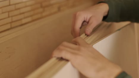 woodworker professional hands checks wood raw, wooden plank, plywood panel