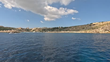 Riding-on-a-boat-and-overlooking-the-coastline-of-Malta-on-a-sunny-day