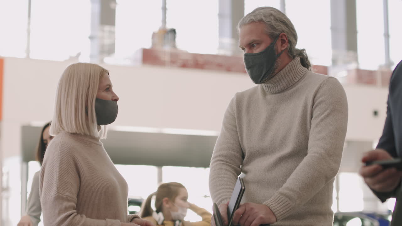 Talking Couple In Queue At Check-In