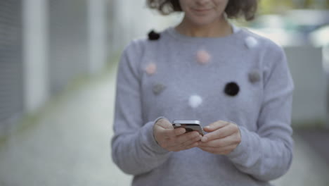 cropped shot of woman holding modern smartphone