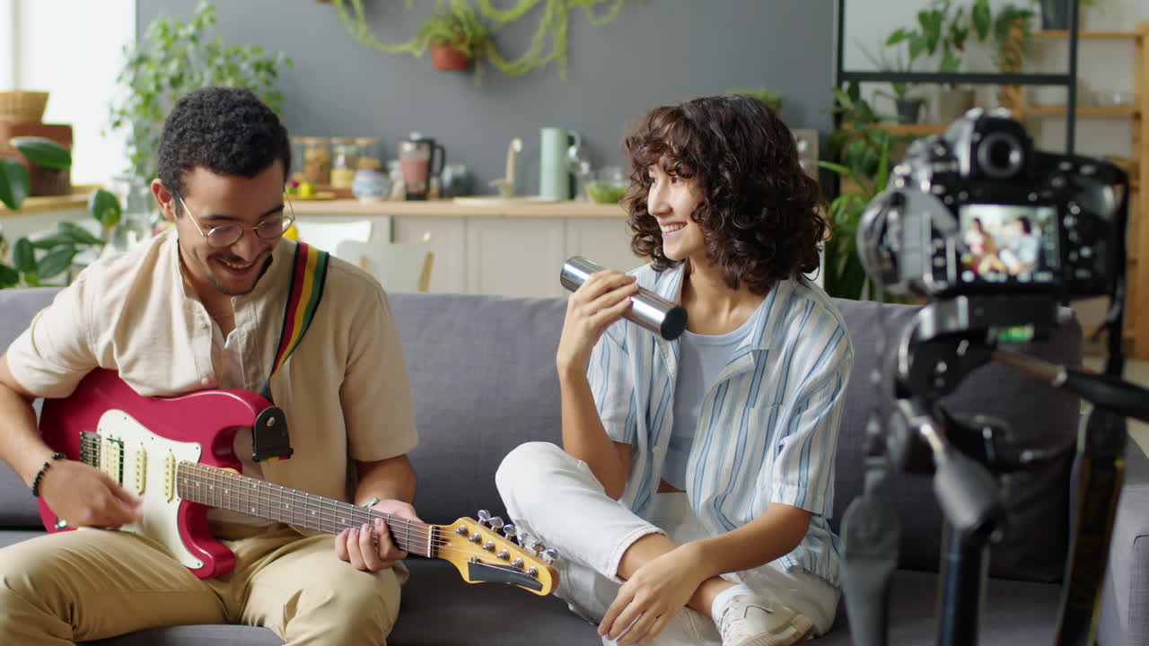 Couple Playing Music and Filming Music Blog at Home