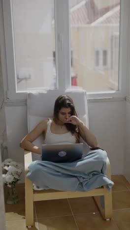 woman working on laptop on a balcony
