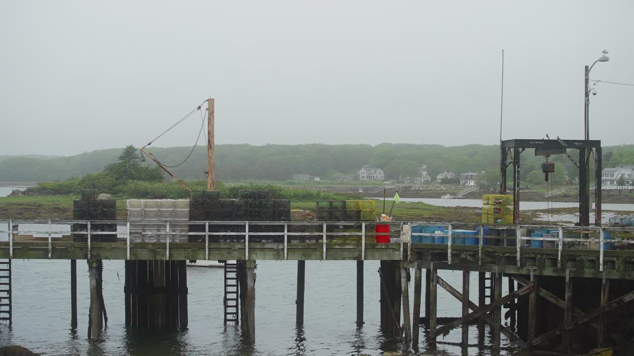 Lobster and commercial fishing dock pier with traps and mechanical lift 4k 60p