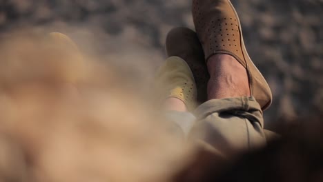 Couple-relaxing-together-outdoors-with-their-legs-up,-relationship-concept