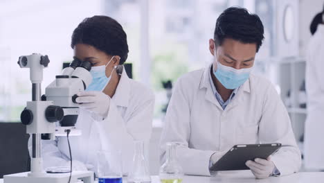 two medical scientists use a tablet