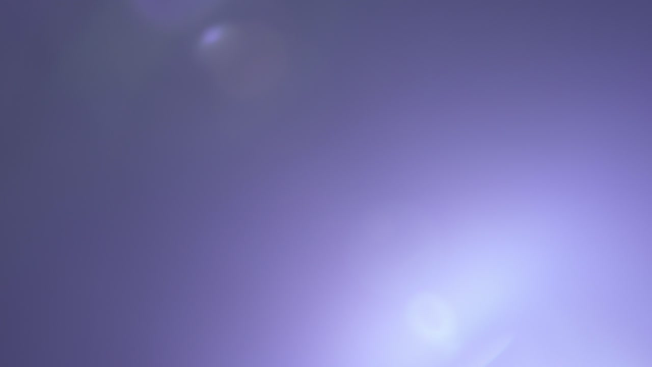 Abstract shot of a light ray flare moving across a black background, creating a clean glowing visual effect