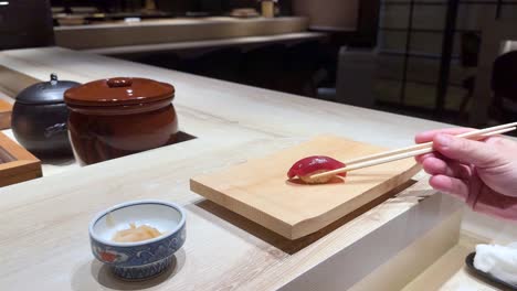 chopsticks picking sushi at a japanese restaurant