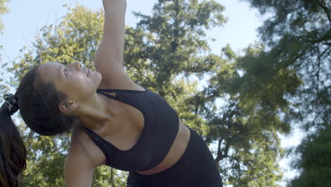 Mujer-Haciendo-Pose-De-Yoga-De-Perro-Hacia-Arriba-En-Un-Hermoso-Parque-Soleado