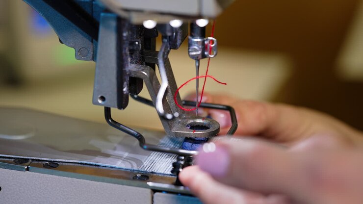 Sewing modern machine close up. Textile needle sewing equipment.
