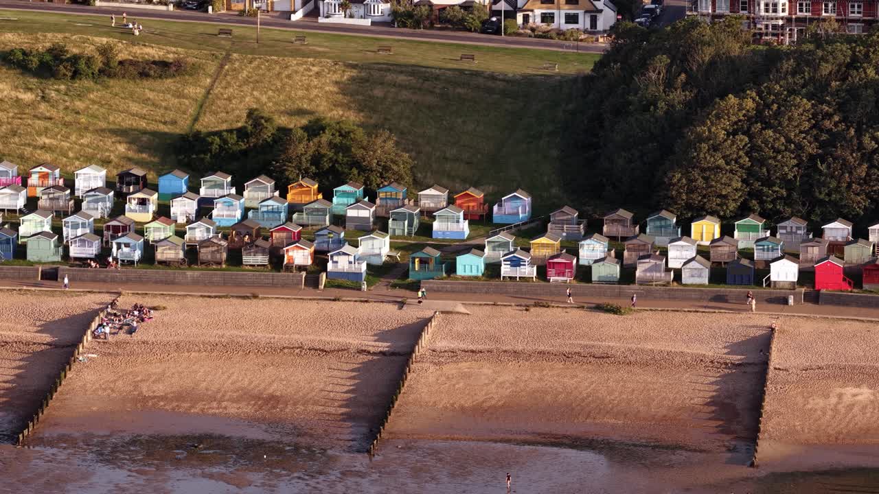 Scenic beach huts line Whitstable's sandy shore, evoking serene coastal vibe