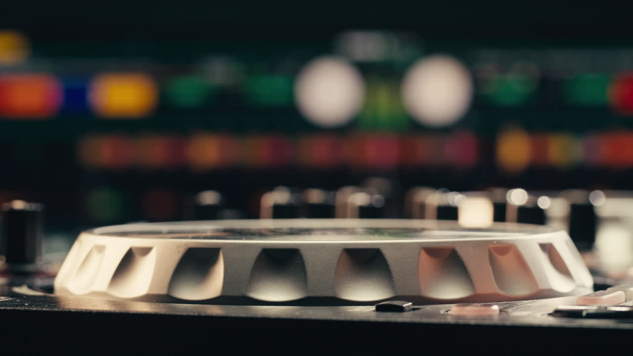 DJ with headphones and sunglasses playing music on festival in night club. Techno musician performing at nightclub for concert crowd of people, city bar.
