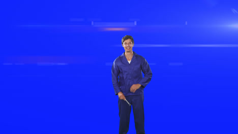 caucasian worker man wearing a blue overwall smiling at the camera in a blue backgroud