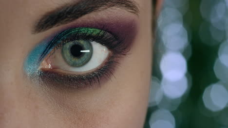 close up beautiful woman eye wearing colorful makeup cosmetics evening nightlife concept