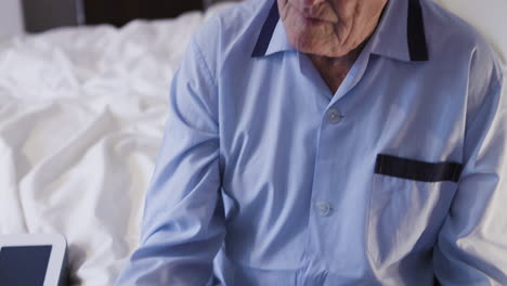 elderly man in pajamas in bedroom