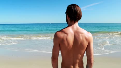 Man-standing-on-beach