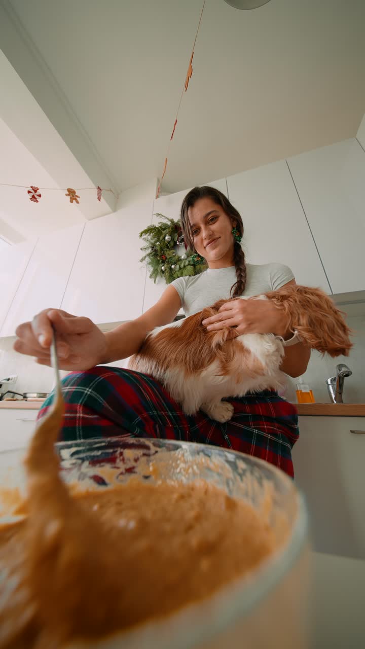 Woman baking with her dog at Christmas