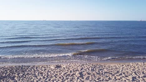 Aerial-Shot-Of-Young-Couple-Sitting-On-Sandy-Beach,-Hugging,-Holding-Hands