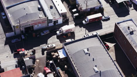 Aerial view of an industrial and warehouse district with trucks and cars