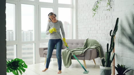 woman cleaning her home with music