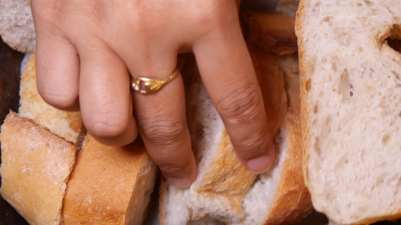 Close-up of sliced bread with hand