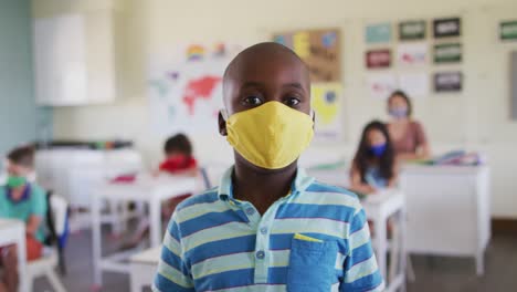 portrait of boy wearing face mask in class at school