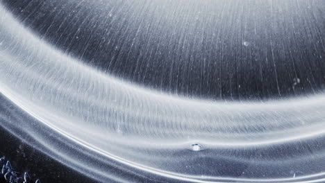abstract white ink creates radiant rings in this artistic macro fluid motion
