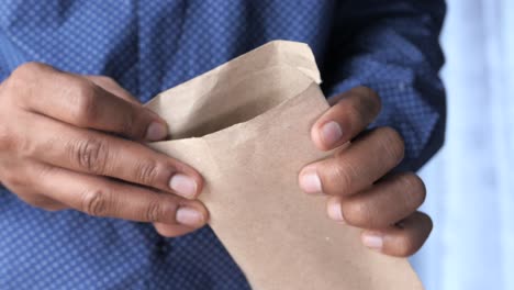 man putting money in envelope