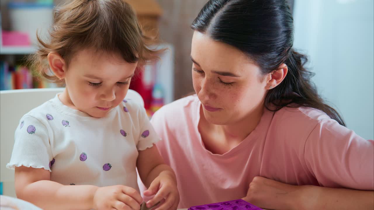 A Heartwarming Moment: A Mother Engaging with Her Toddler as They Explore New Activities Together, Creating Joyful Memories Through Play and Learning