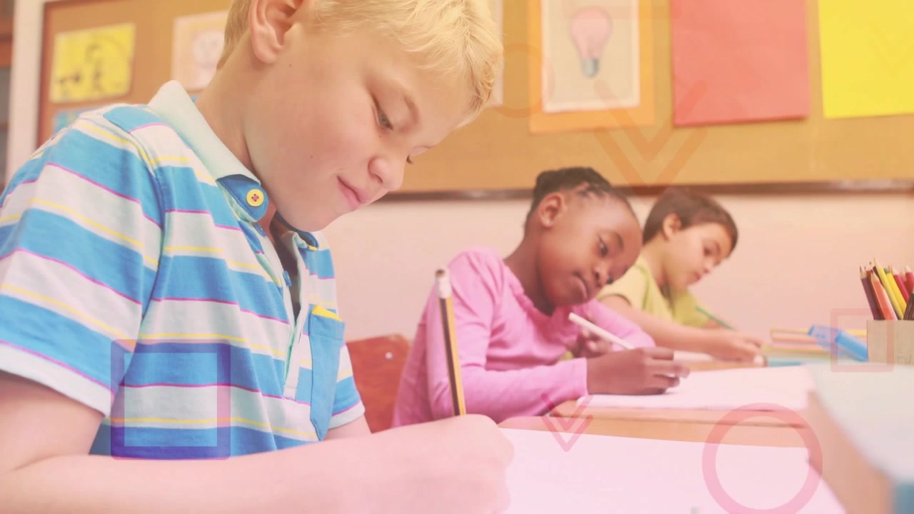 Jongen vooraan schrijft schoolwerk terwijl camera verbreedt, klasgenoten schrijven, roze vormen verschijnen boven papier