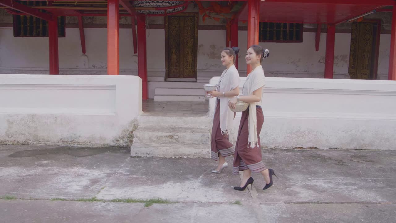 Women in Traditional Thai Clothing Visiting a Temple
