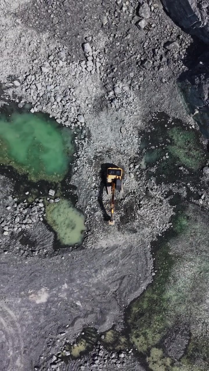 Detail of granite quarry high walls and rocky texture aerial