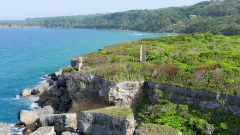 still shot of the french cape a cliff with vegetation, beautiful sea in the background